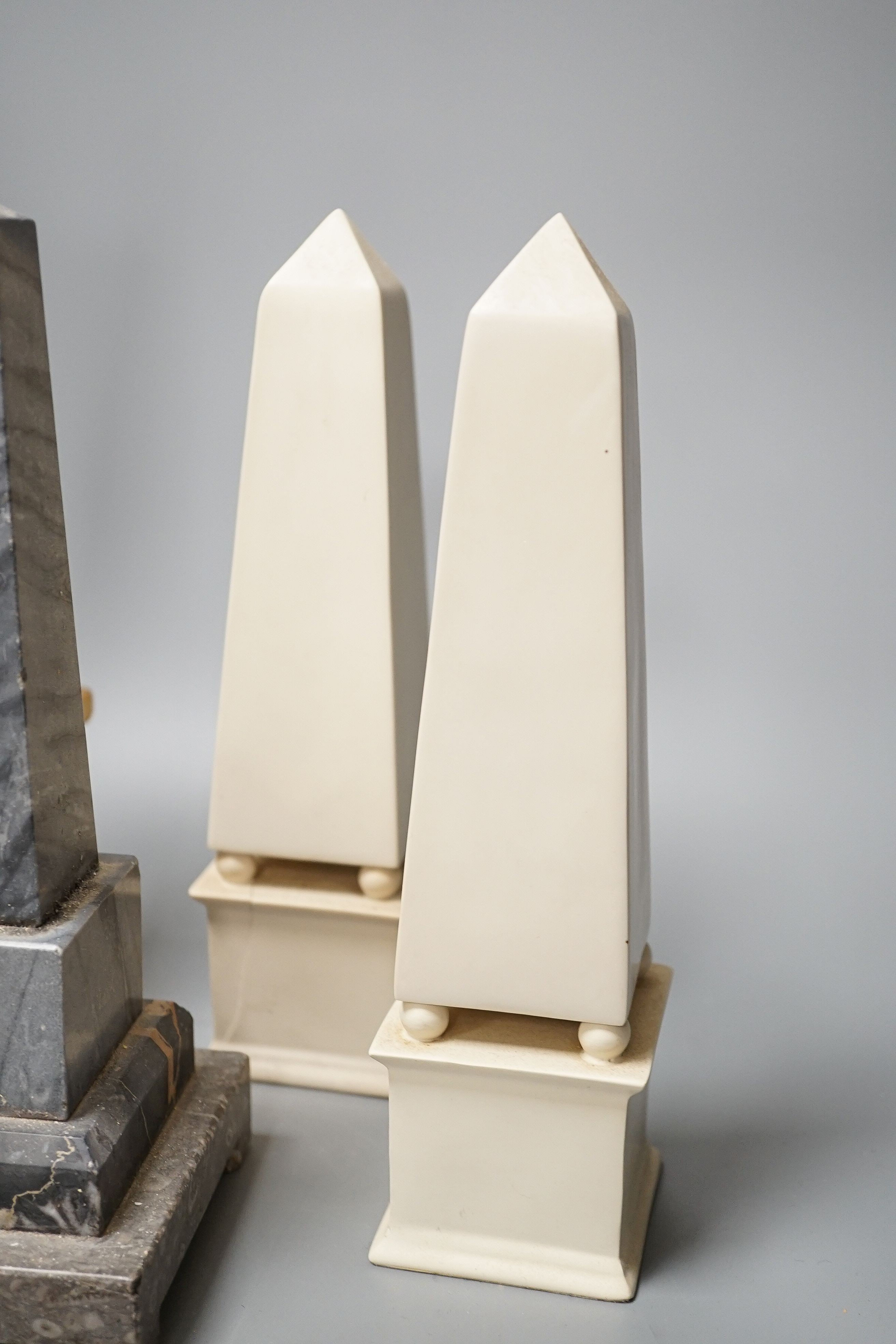 Two pairs of simulated stone obelisks, another pair and a single, tallest 33cm